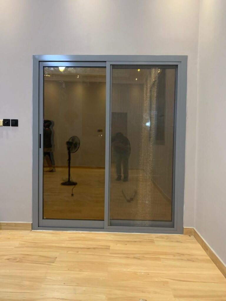 Grey aluminium sliding door with fly screen