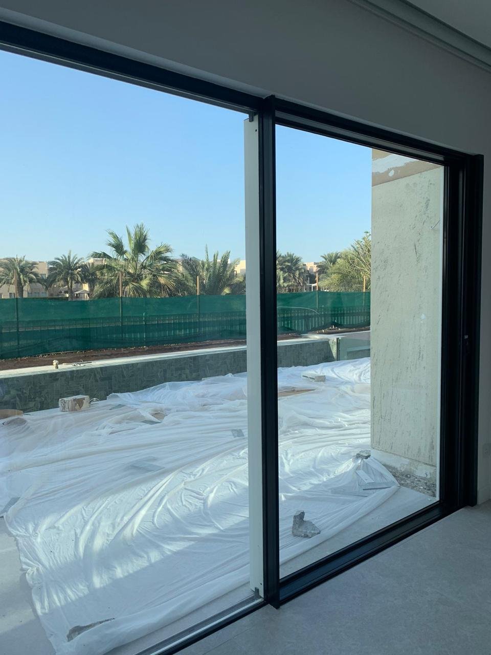 Aluminium sliding doors opening onto a pool terrace