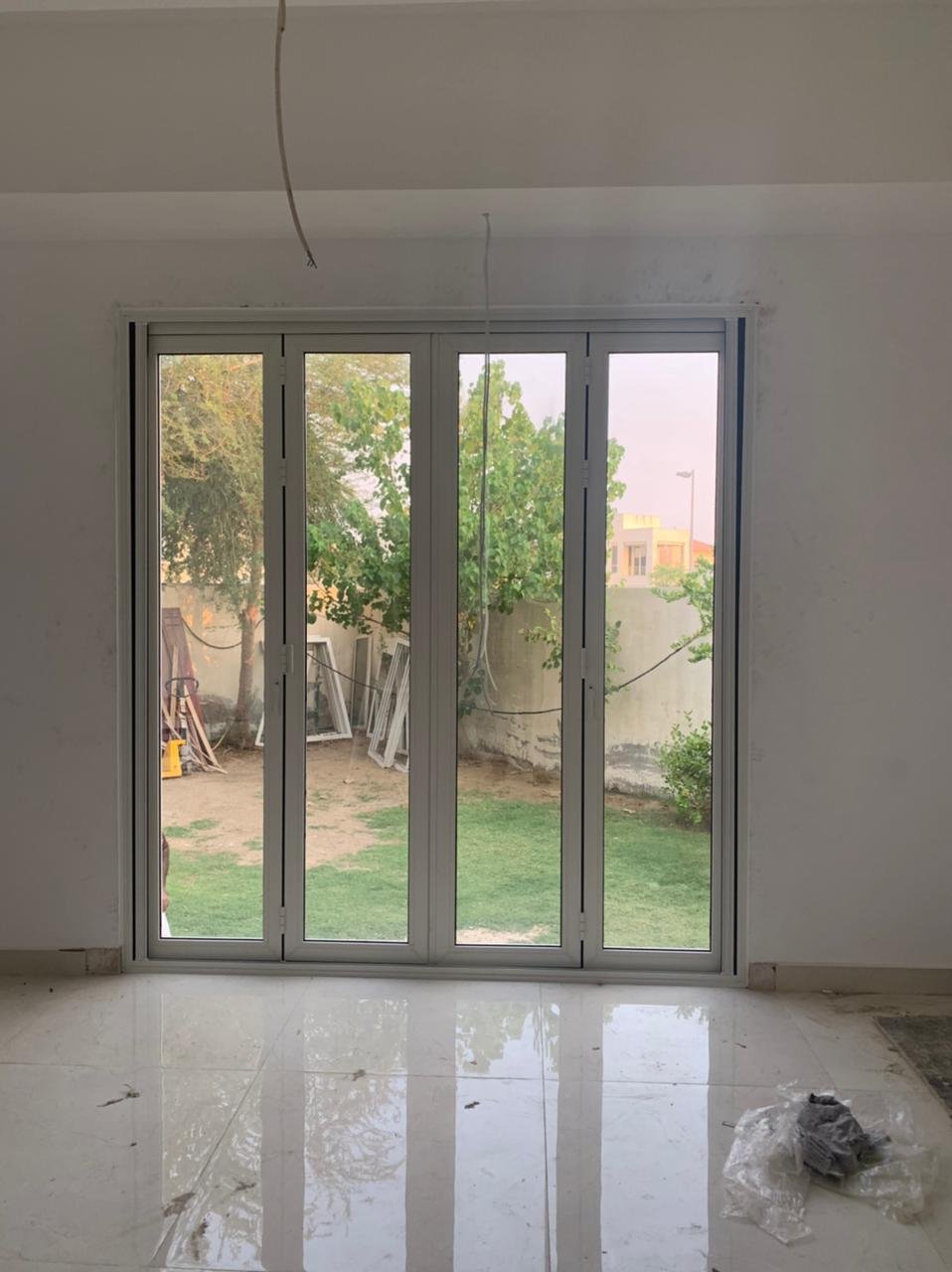White aluminium bi-folding door, villa interior